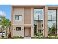 Modern two-story home with large windows and neutral color scheme at 3112 Rockefeller Way, Kissimmee, FL 34747