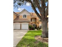 Two-story townhome with two-car garage and landscaped yard at 7429 Green Tree Dr # 96, Orlando, FL 32819