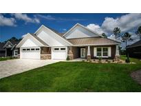 Modern farmhouse exterior with three-car garage at 6437 Sw 180Th Cir, Dunnellon, FL 34432