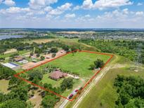 Aerial view of a house on a large lot with lush green surroundings at 16300 Johns Lake Rd, Clermont, FL 34711