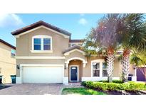 Two-story house with a two-car garage and landscaped front yard at 8920 Bengal Ct, Kissimmee, FL 34747