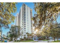 High-rise building with lush landscaping at 530 E Central Blvd # 1002, Orlando, FL 32801