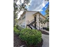 Two-story building with light yellow siding and a staircase at 1027 S Hiawassee Rd # 2313, Orlando, FL 32835