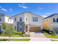 Two-story house with stone accents and attached garage at 9025 Sunshine Ridge Loop, Kissimmee, FL 34747