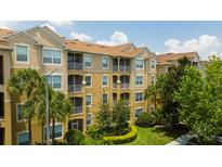 Three-story apartment building with balconies and lush landscaping at 2813 Almaton Loop # 301, Kissimmee, FL 34747