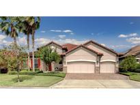 House exterior with three-car garage and palm trees at 5769 Saybrook Cir, Sanford, FL 32771