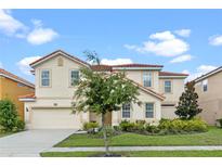 Two-story house with a well-manicured lawn and driveway at 6032 Broad Oak Dr, Davenport, FL 33837