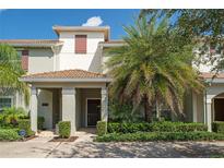 Two-story light-grey townhouse with dark brown door at 4803 Brier Rose Ln, Kissimmee, FL 34746