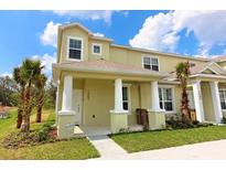Two-story townhome with front porch and landscaping at 1507 Tranquil Ave, Clermont, FL 34714