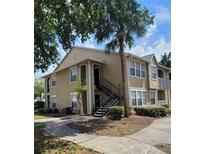 Tan building with stairs and landscaping at 1029 S Hiawassee Rd # 2414, Orlando, FL 32835