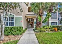 Attractive building exterior with landscaping and walkway at 4865 Cypress Woods Dr # 2204, Orlando, FL 32811