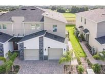 Modern townhouse exterior with two-car garage and walkway at 619 Ocean Course Ave # 619, Davenport, FL 33896