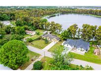 Aerial view of lakefront property with two houses at 16837 Arrowhead Blvd, Winter Garden, FL 34787