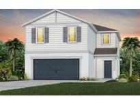 Two-story home with a dark gray garage door at 2118 Charming Ave, Davenport, FL 33897