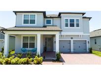 Two story home with gray siding and two-car garage at 13978 Lanyard Way, Winter Garden, FL 34787