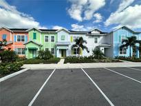 Colorful townhouses with parking and landscaping at 2972 On The Rocks Pt, Kissimmee, FL 34747