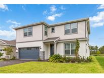 Two-story home with gray garage door and landscaping at 6030 Arbor Watch Loop, Orlando, FL 32829