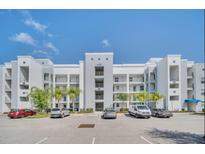 Modern apartment building with ample parking and landscaping at 4741 Clock Tower Dr # 208, Kissimmee, FL 34746