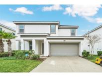 Two-story house with attached garage and landscaping at 320 Ballo Dr, Kissimmee, FL 34746