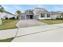 Two-story house with a large driveway and landscaped yard at 3394 Buoy Cir, Winter Garden, FL 34787