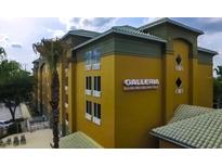 Galleria Palms Hotel exterior view, showing building and landscaping at 3000 Maingate Ln # 522, Kissimmee, FL 34747