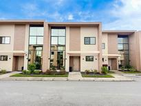 Modern townhome with large windows and stone accents at 3114 Rockefeller Way, Kissimmee, FL 34747