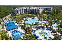 Aerial view of resort-style community with large pool and water features at 14501 Grove Resort Ave # 2740, Winter Garden, FL 34787