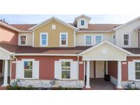 Two-story townhouses with inviting front porches and landscaping at 7529 Sunflower Cir, Kissimmee, FL 34747