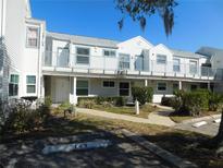 Exterior view of a two-story building with multiple units at 2540 Woodgate Blvd # 204, Orlando, FL 32822