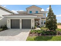 Two-story house with stone accents and a two-car garage at 15820 Vetta Dr, Montverde, FL 34756
