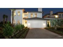 Stunning two-story home with a white exterior and brick driveway at 4007 Grande Brick Loop # 13, Orlando, FL 32837