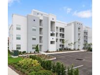 Modern building exterior with parking spaces at 4751 Clock Tower Dr # 402, Kissimmee, FL 34746