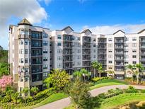 Elegant condo building with lush landscaping at 14501 Grove Resort Ave # 3327, Winter Garden, FL 34787