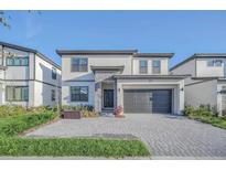 Modern two-story home with attached garage and landscaping at 6115 High Seas Dr, Orlando, FL 32821