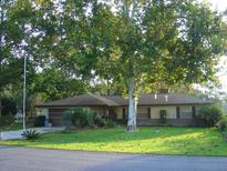Charming ranch home with mature landscaping and a large tree in the front yard at 1333 N Fowler Dr, Deltona, FL 32725