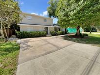 Two-story house with a large driveway and mature trees at 326 Banyan Dr, Maitland, FL 32751
