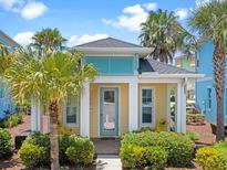 Bright yellow beach cottage with teal accents at 3054 Pirate Way, Kissimmee, FL 34747