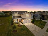Two-story home with stone facade and two-car garage at 5039 Ne 125Th Loop, Oxford, FL 34484