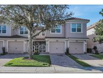 Beautiful two-story townhome with attached garage and landscaped yard at 8316 Fontera Dr, Davenport, FL 33896