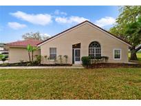 Tan house with a tiled roof and lush landscaping at 2546 Albion Ave, Orlando, FL 32833