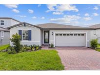 Charming house exterior with gray siding and brick driveway at 1353 Hanoverian Dr, Lake Alfred, FL 33850