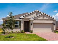 Beautiful home with two-car garage and well-manicured lawn at 1860 Ross Hammock Ave, Groveland, FL 34736