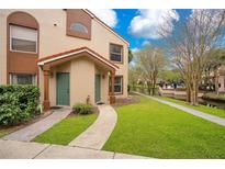 Townhouse exterior with walkway and landscaping at 5460 E Michigan St # 7, Orlando, FL 32812