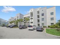 Modern building exterior with ample parking at 4721 Clock Tower Dr # 304, Kissimmee, FL 34746