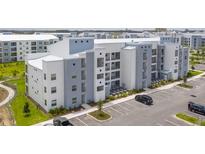 Modern apartment building with ample parking and landscaping at 3180 Paradox Circle # 203, Kissimmee, FL 34746