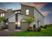 Modern two-story home with two-car garage and landscaped front yard at 897 Ocean Course Ave # 102, Davenport, FL 33896
