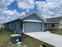 Single-story home with gray siding and a two-car garage at 530 Tanaro Ln, Haines City, FL 33844