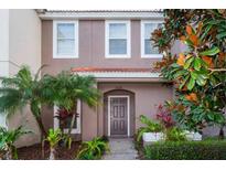 Two-story home with dark brown door and landscaping at 4564 Ada Ln, Kissimmee, FL 34746