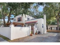 Front view of a white stucco house with a gated entry at 2019 S Park Ave, Sanford, FL 32771