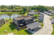 Aerial view of condo unit with private carport and pond view at 2920 Pecan Ave, Leesburg, FL 34748